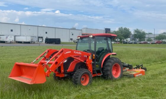 Heavy equipment performing land clearing in a field